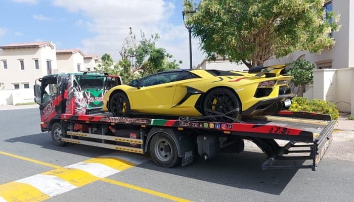 Lamborghini Aventador SVJ being transported on a flatbed truck in Dubai by TRT Recovery