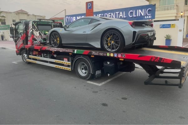 Ferrari 488 Pista being transported on a flatbed truck in Dubai by TRT Recovery