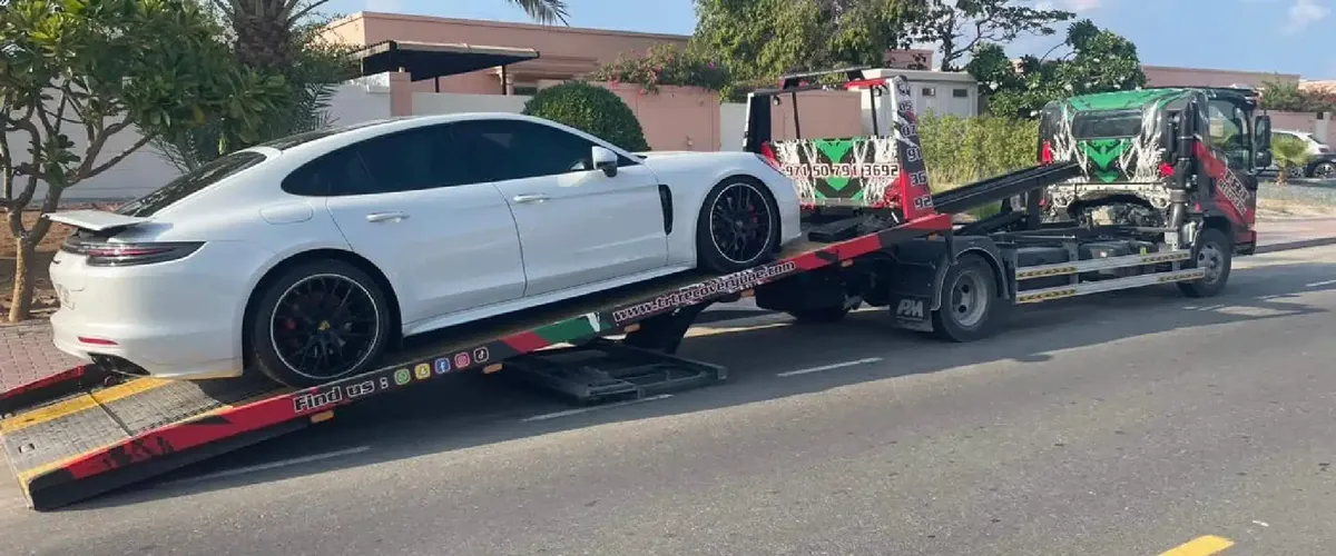 Driver performing car and motorcycle towing services in Dubai