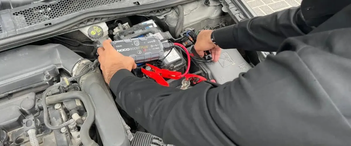 Technician providing battery jump start in Dubai