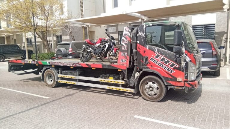 TRT Recovery motorcycle towing Dubai, technician safely recovering a Ducati