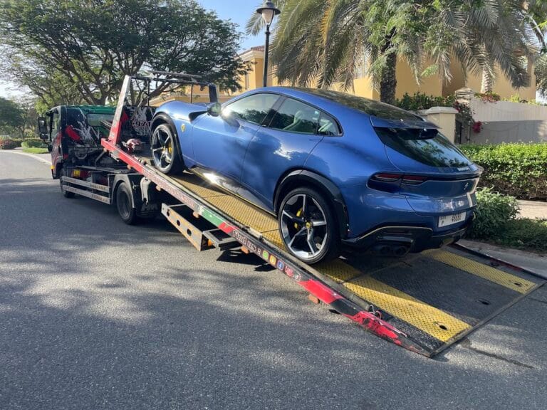 Car towing Dubai, TRT Recovery flatbed truck towing a vehicle with professionalism