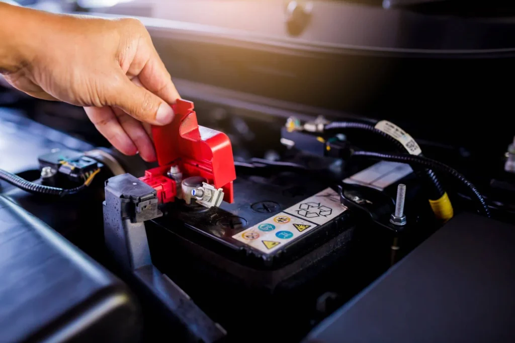 Technician performing a car battery replacement Dubai